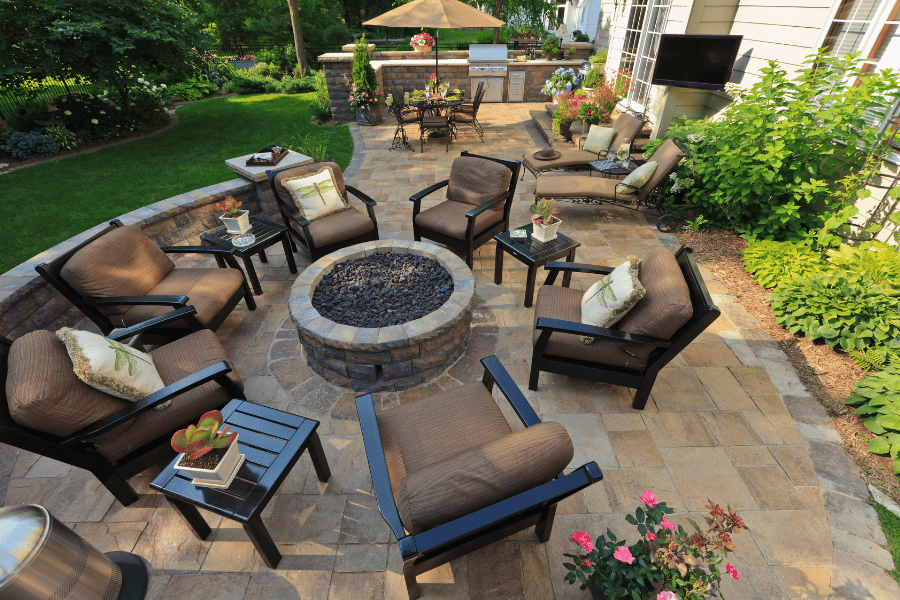 Beautiful garden patio in the backyard with a fireplace and seating