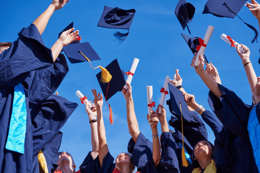 college graduates celebrating with diplomas