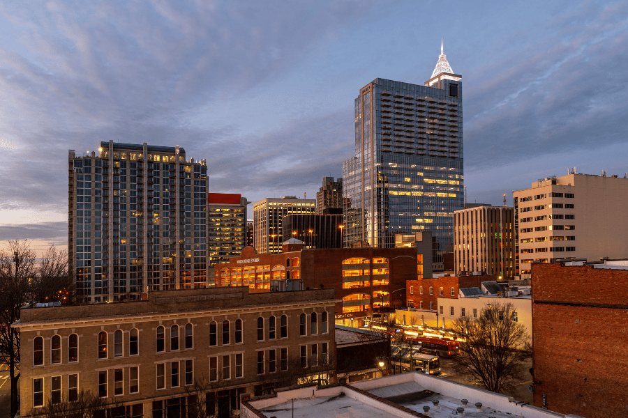 Raleigh Skyline at Sunrise with well-lit buildings 