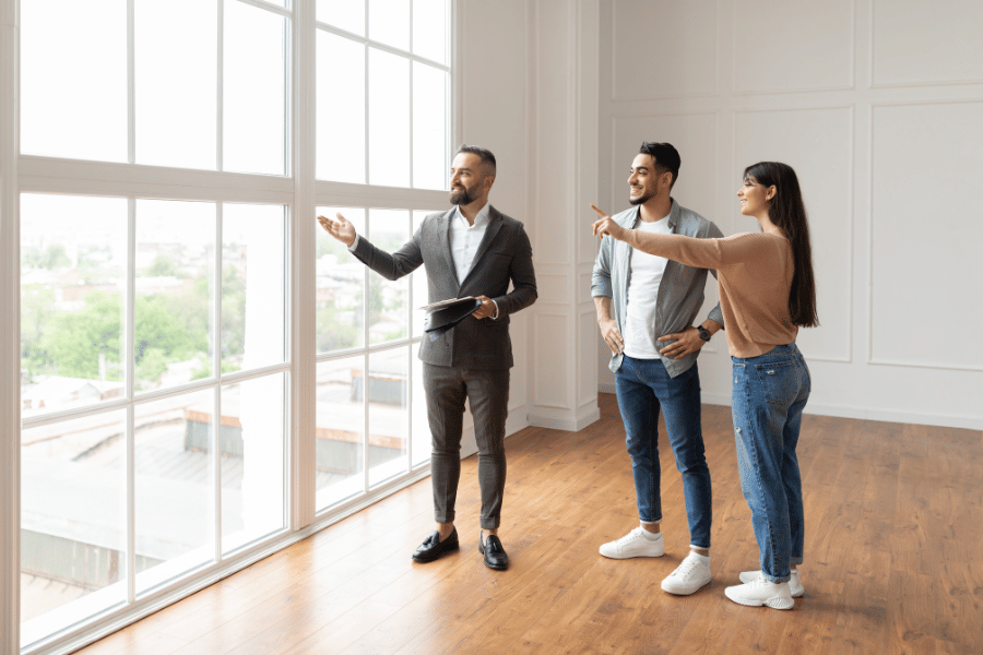 real estate agent showing property with large windows