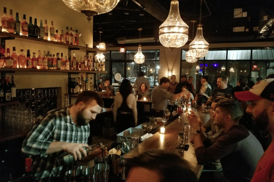 bartender pouring a drink at bar