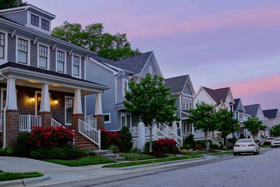 Homes in a neighborhood in Raleigh with pink sunset in background