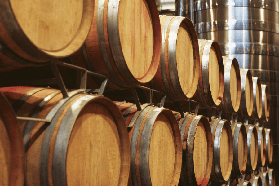 wine barrels stacked together at a winery 