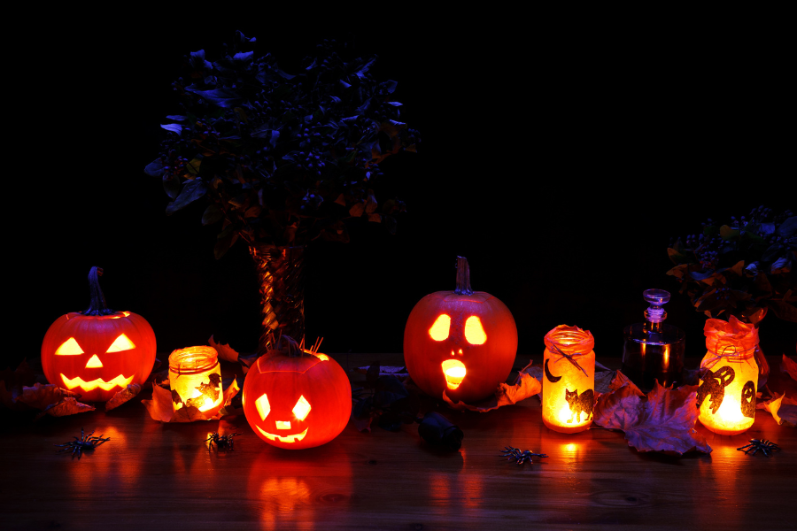 Jack-O-Lanterns lit up on ground in the dark