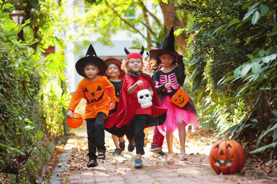 kids dressed up for halloween and trick or treating in their costumes