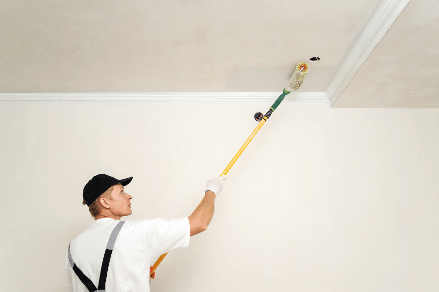 Professional painting a ceiling