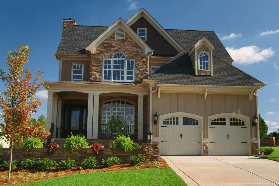 suburban home with 2 garage doors and a front porch 