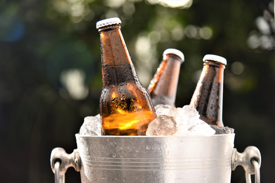 Silver ice bucket with brown bottles of beer