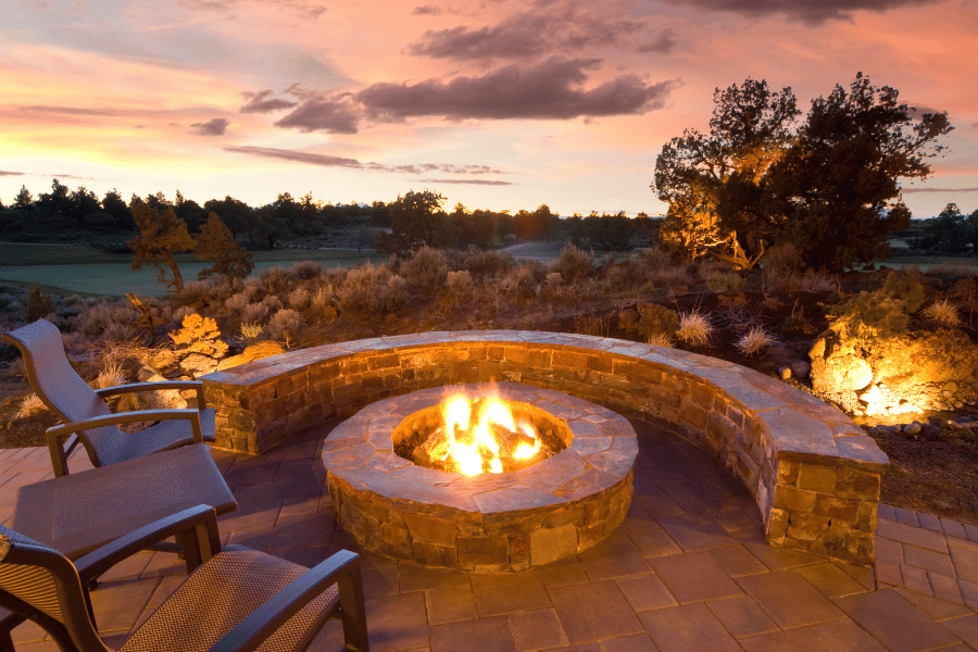 beautiful backyard stone circle fire pit with bench seating