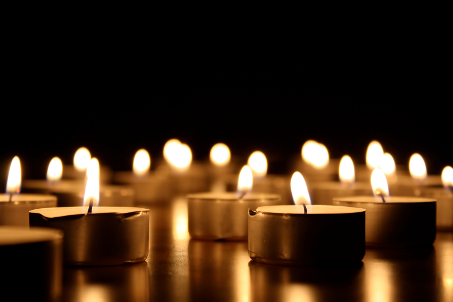 Photo of tea light candles lit in the dark