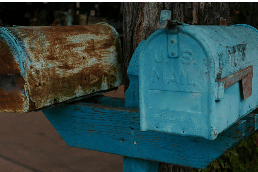 Rusted mailboxes in need of repainting and priming