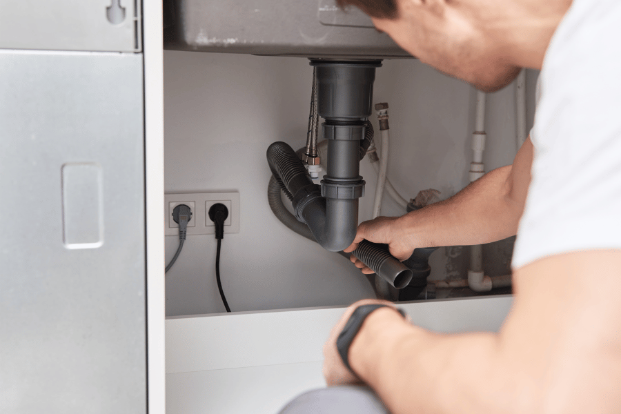 repairing plumbing under the kitchen sink for under contract home