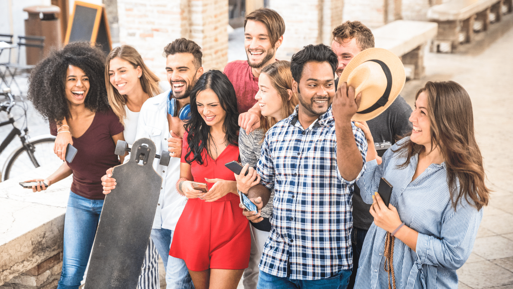 Millennial friends walking down the street holding their phones