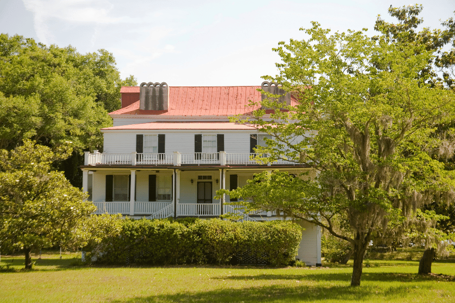 beautiful historic home with red roof and front porch