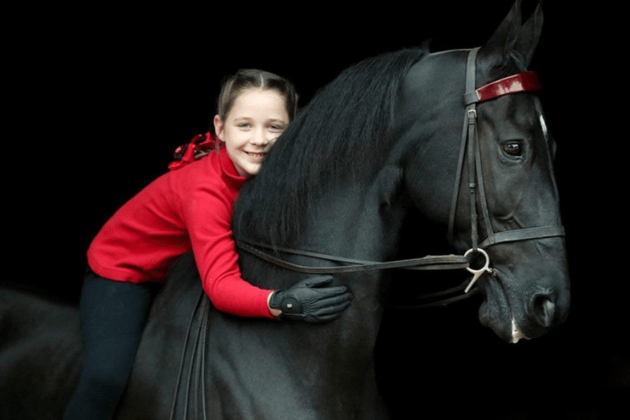 riding a black horse at ingleside farm