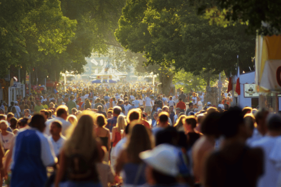 large crowd of people walking at the state fair