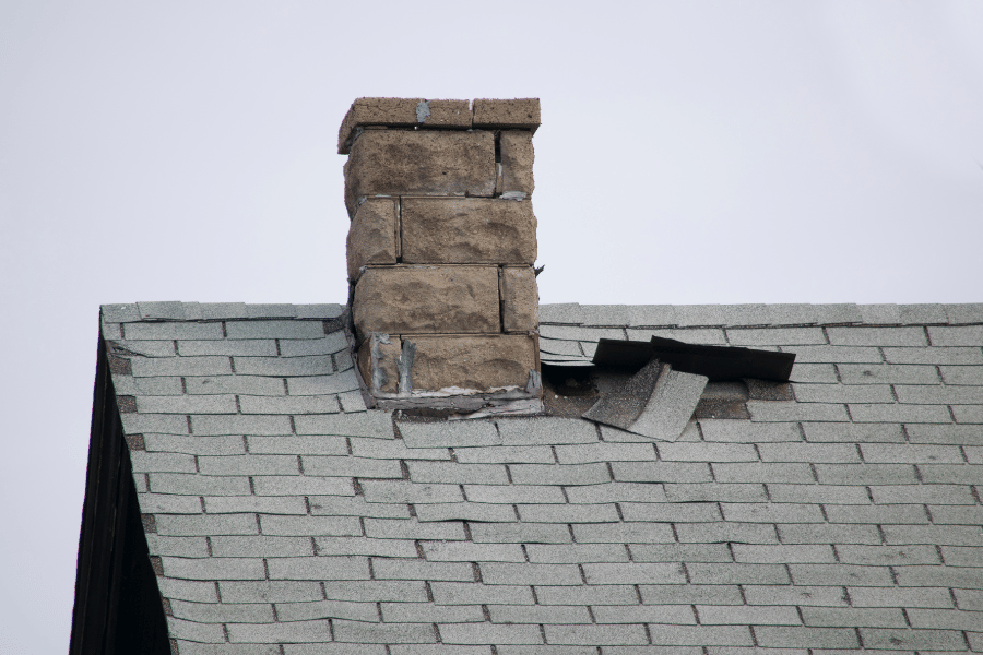 Roof damage on home with chimney