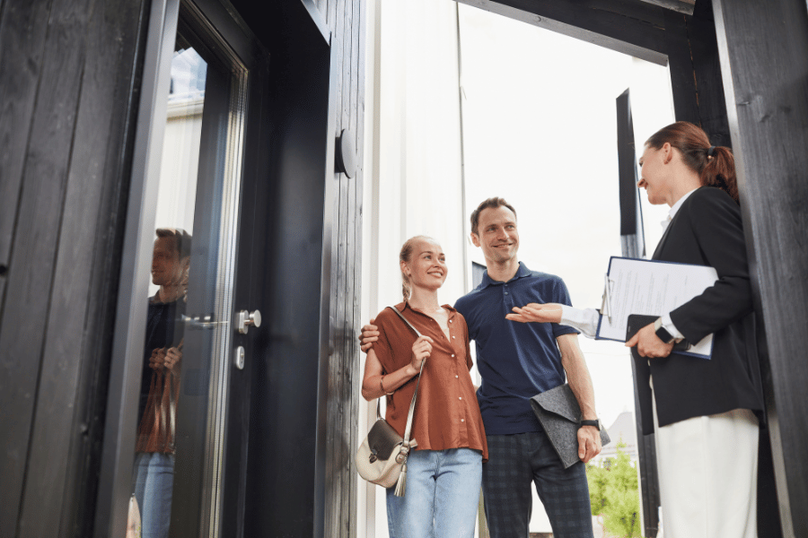 Real estate agent showing a home for sale to clients