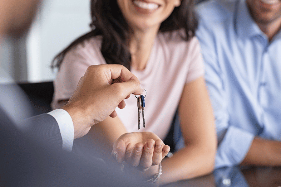 New home buyers getting keys to new home after home process