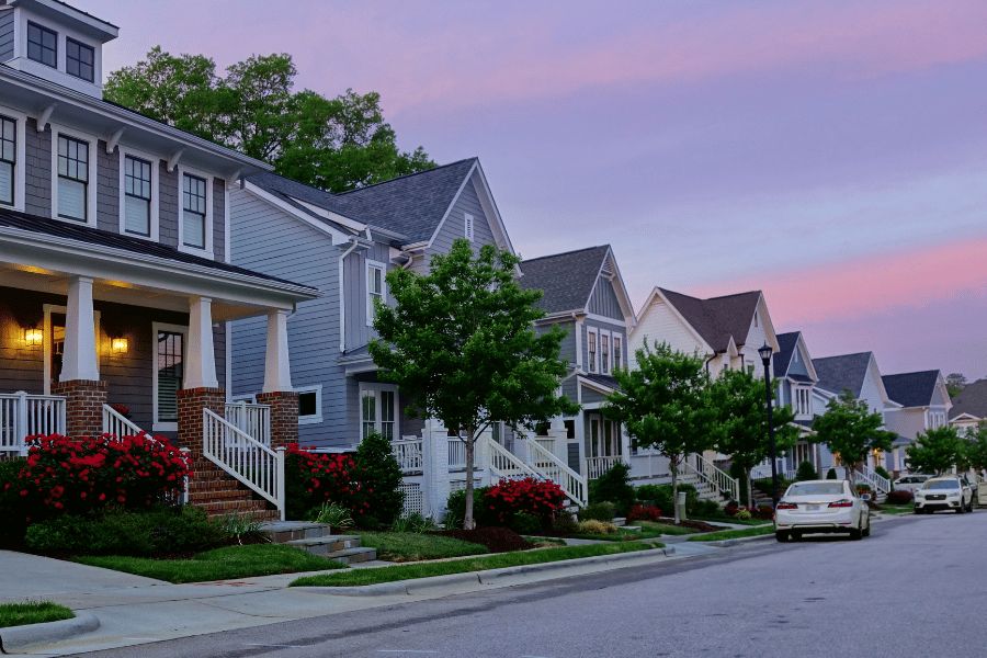 Neighborhood homes in Raleigh NC with pink sunset behind