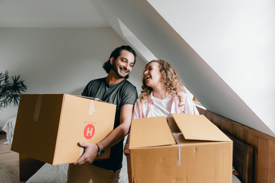 couple moving into a new home with moving boxes