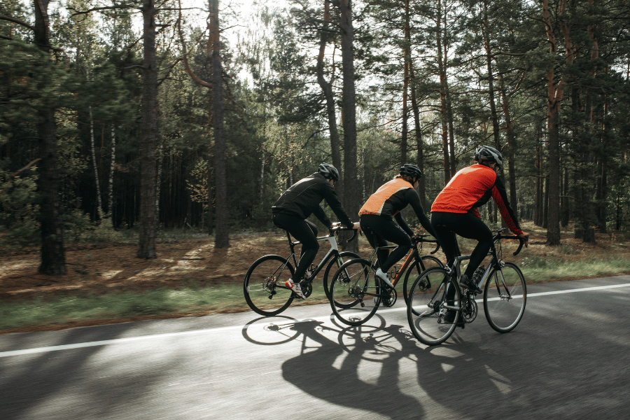 three bikers riding on a trail surrounded by trails