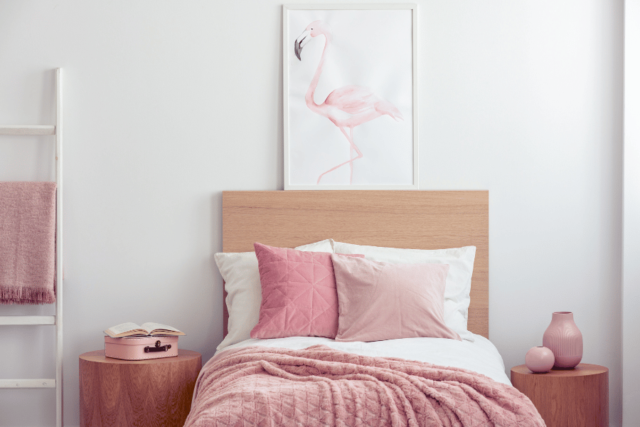 cute pink girls kids room with a flamingo painting above the bed