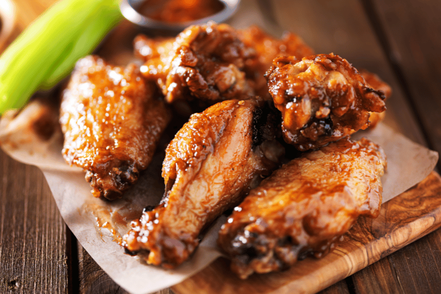 chicken wings with sauce and celery sticks