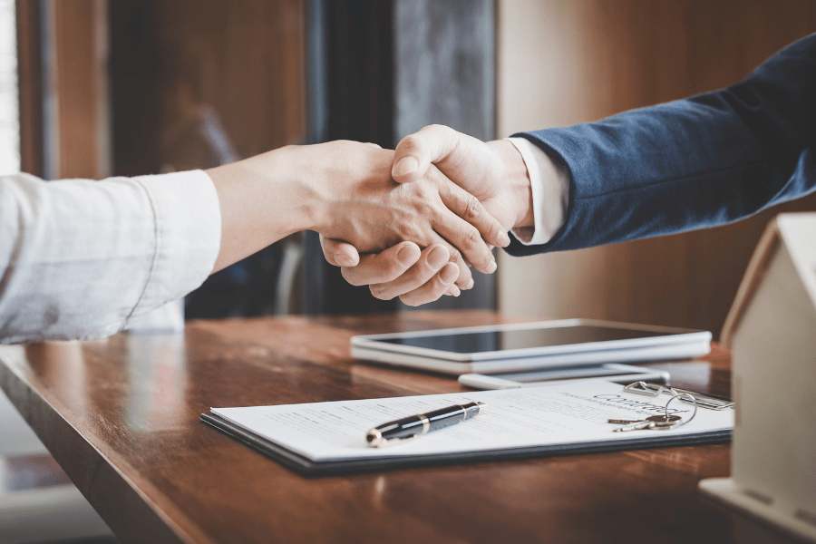 real estate agent shaking hands with a client 