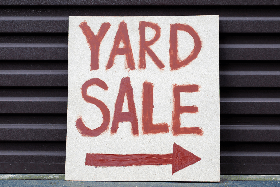 red yard sale sign set up 