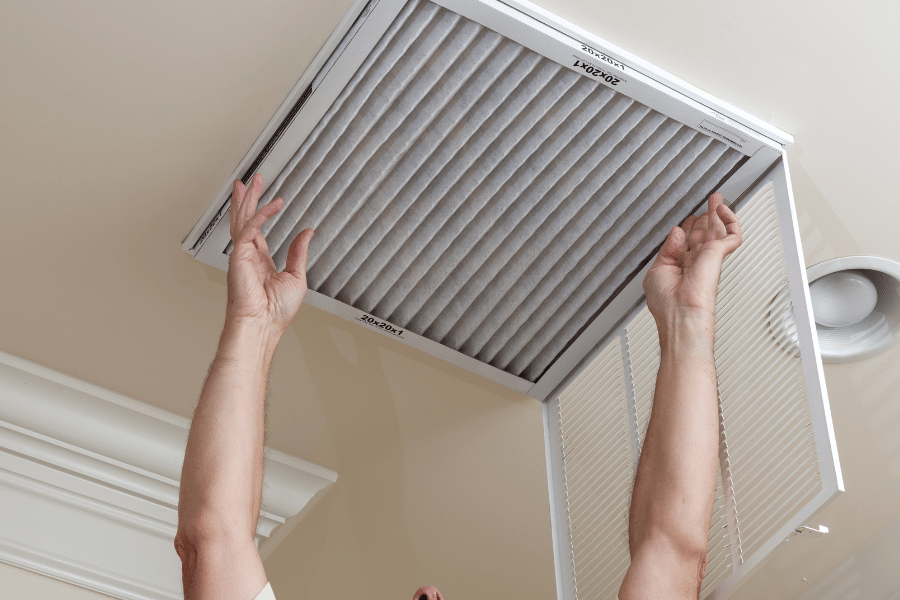 Replacing the air filter in the ceiling of a home