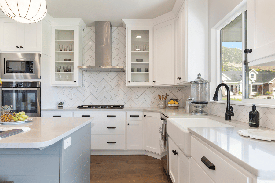 farmhouse sink in a beautiful kitchen with white cabinets