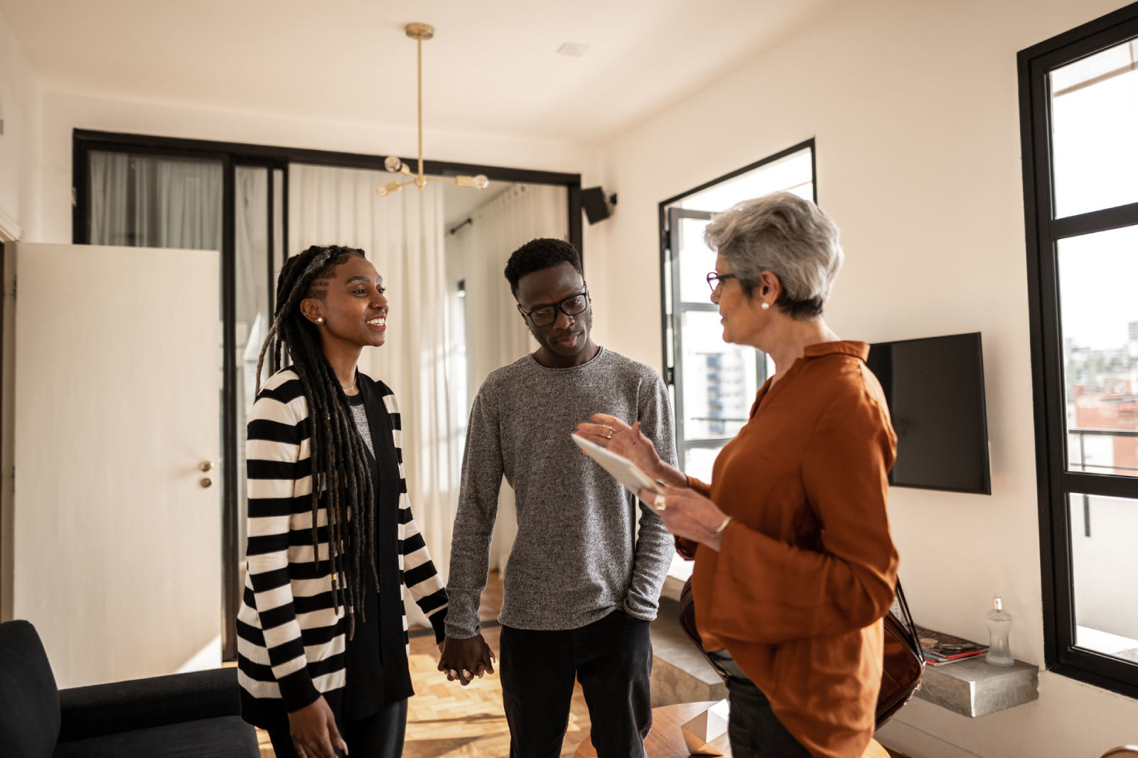 Real estate agent showing a home to a couple in Raleigh.