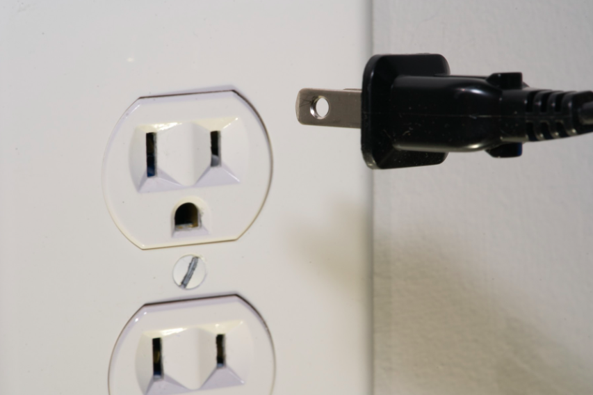 Plugging cord into electric socket 