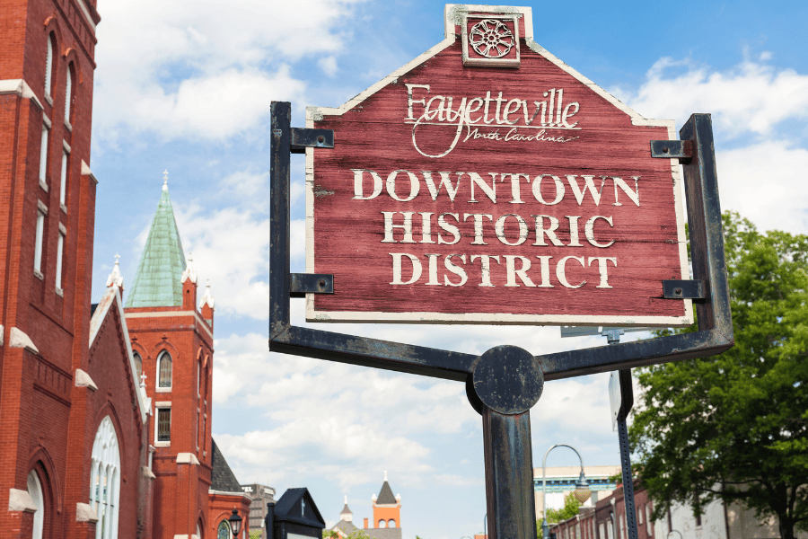 Historic downtown Fayetteville sign with buildings behind