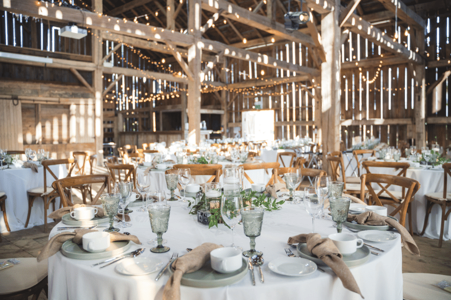 rustic wedding venue in a barn with decorated tables