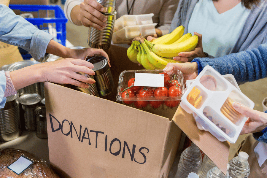 volunteers putting donations into a cardboard box