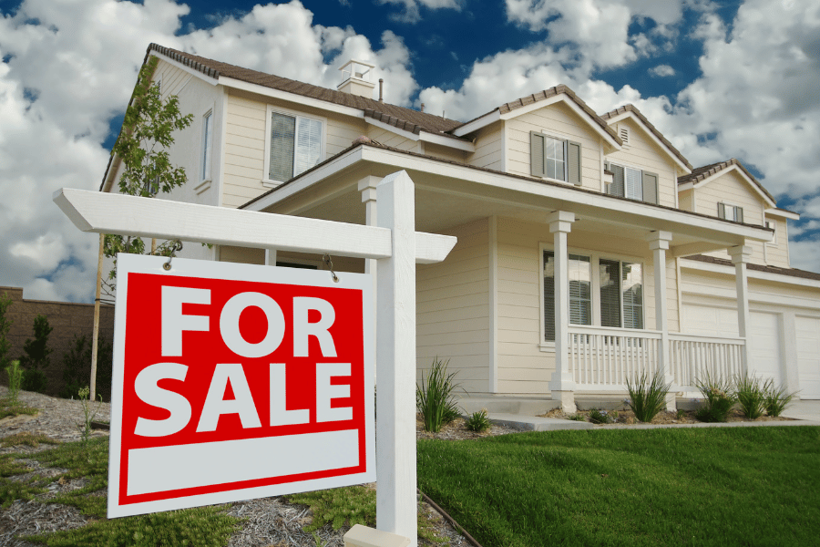 Beautiful single-family home with red for sale sign in the front yard