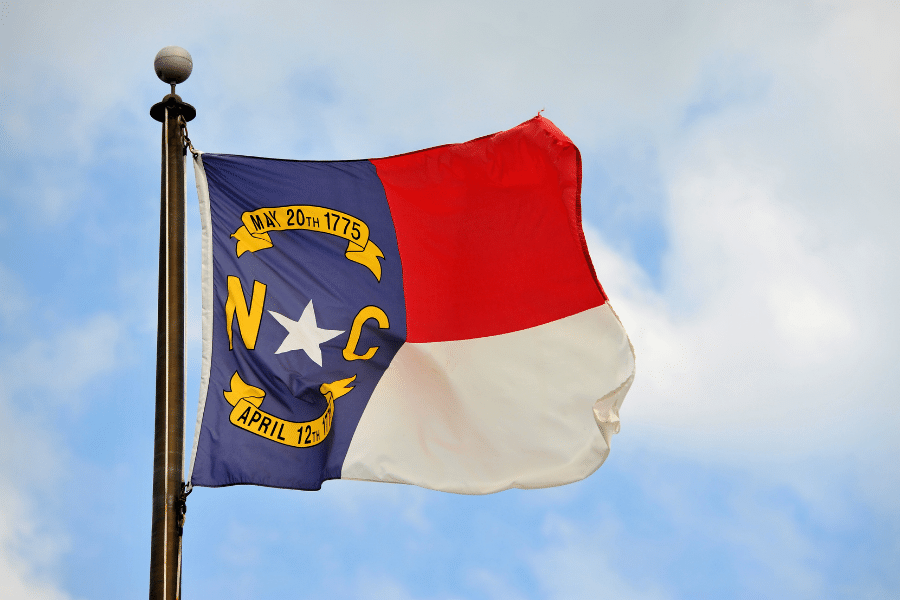 North Carolina flag blowing in the wind on a sunny day
