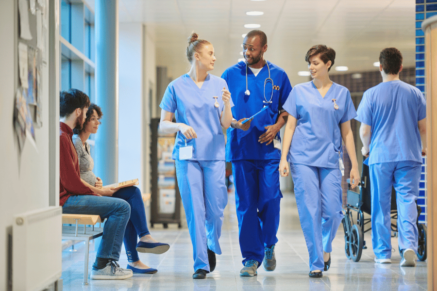 hospital team of doctors and nurses walking throughout the hospital