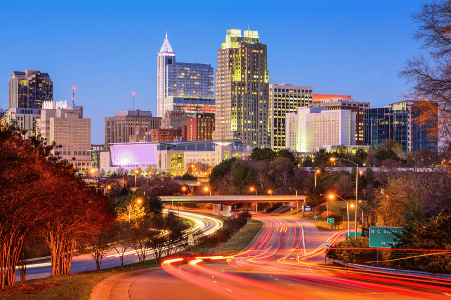Raleigh, NC skyline at night with bright lights and buildings