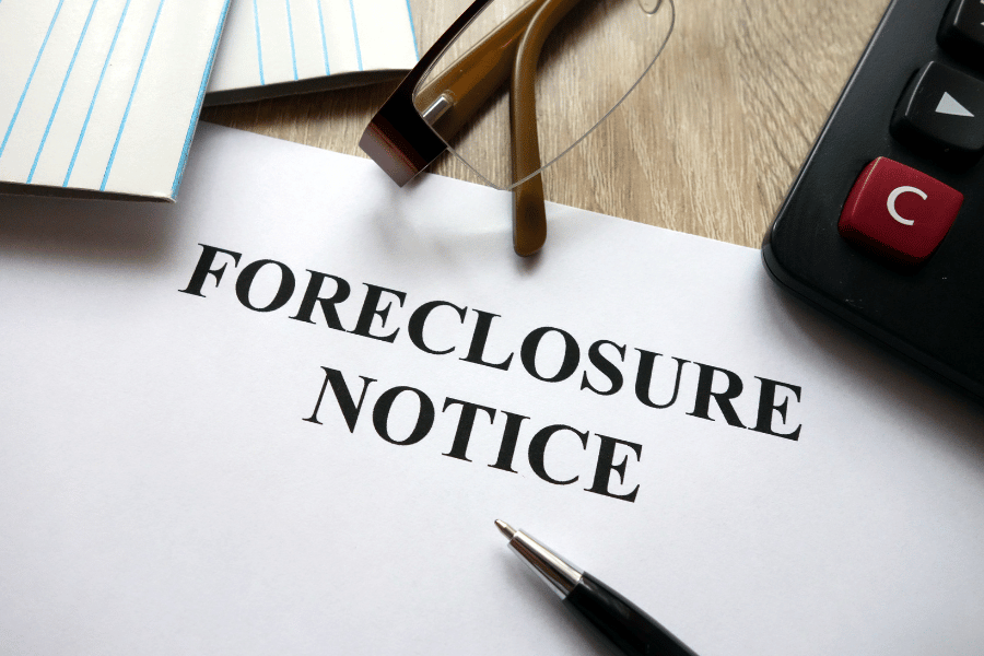 foreclosure notice with a pen on a desk 